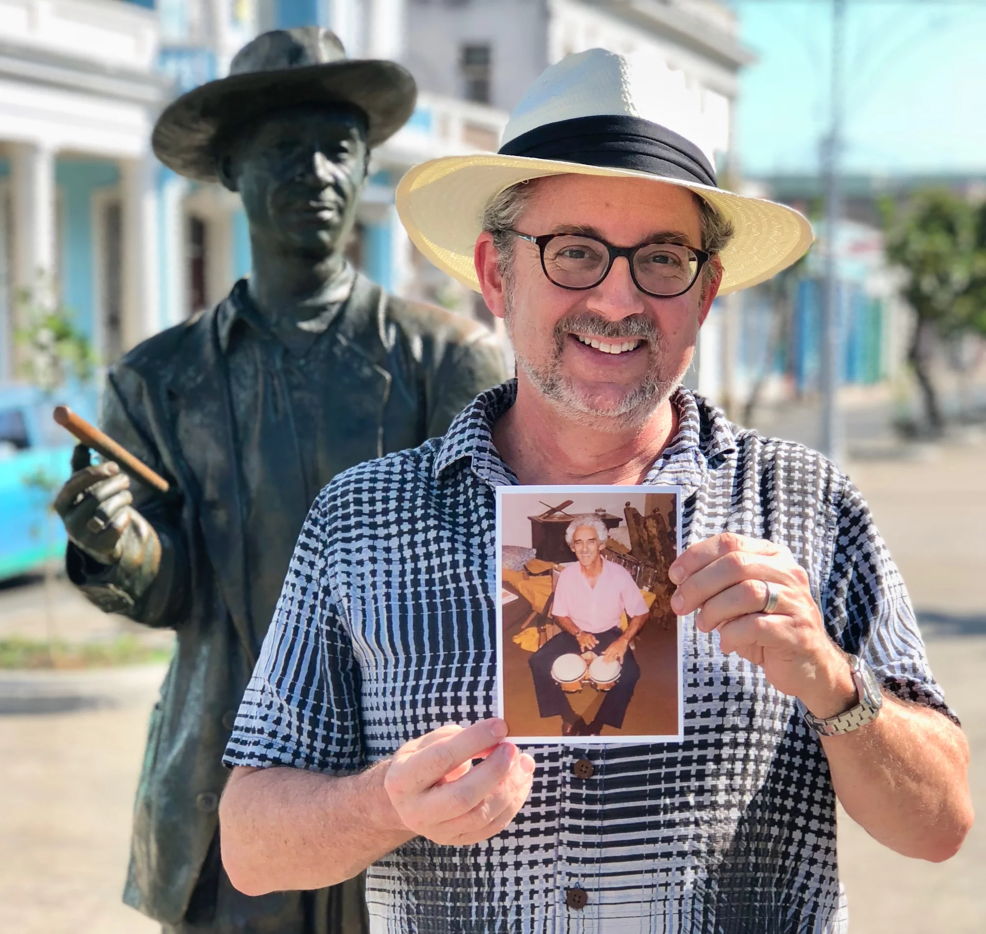 Cuba - Miguel holding a photo of his father at the statue of singer Beny Moré - Cienfuegos